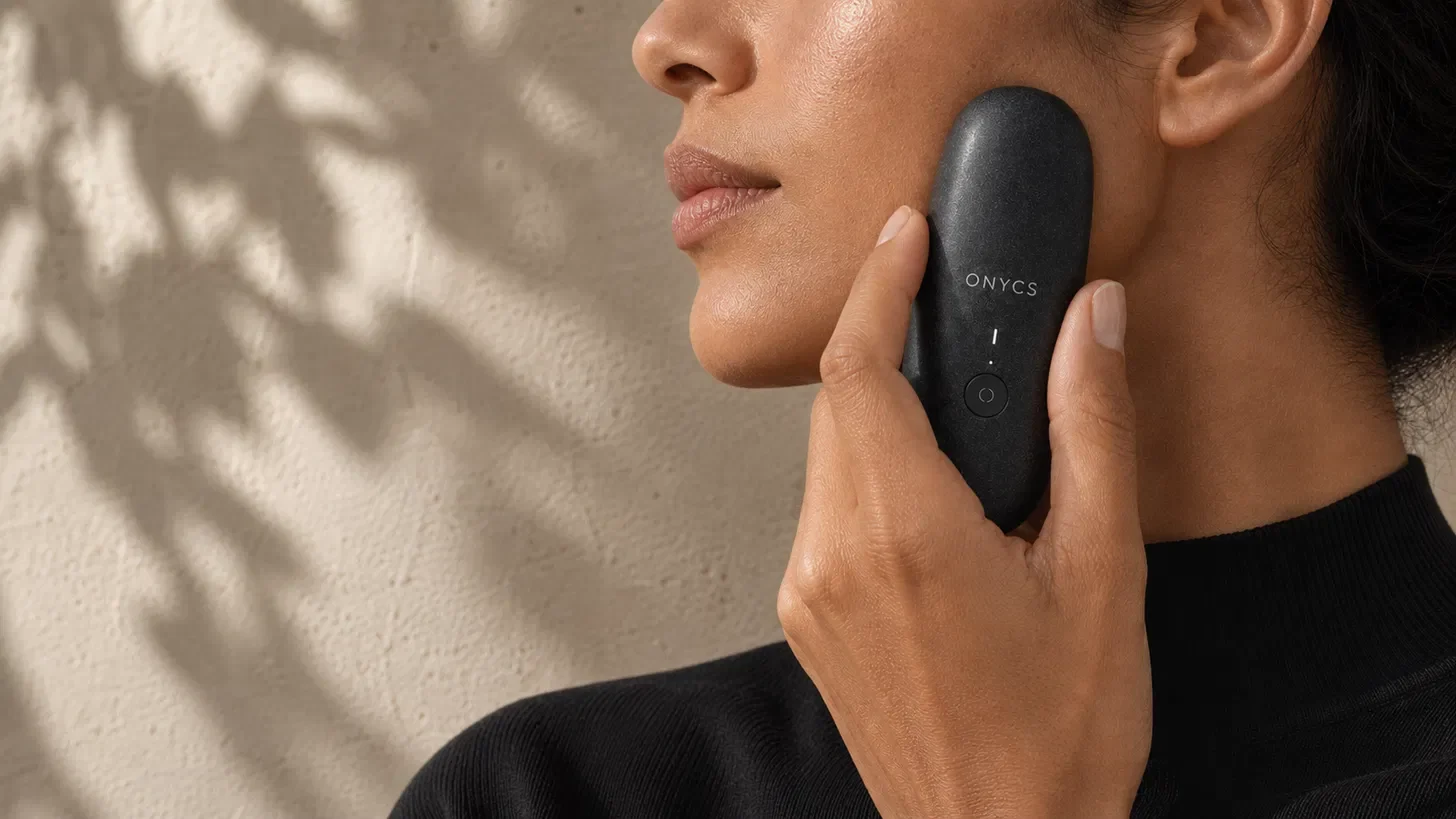 Woman measuring her skin with the ONYCS device